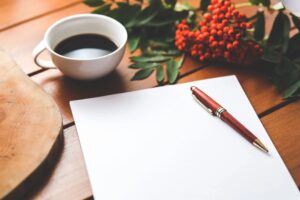 A stock image of papers and writing tools on a desk